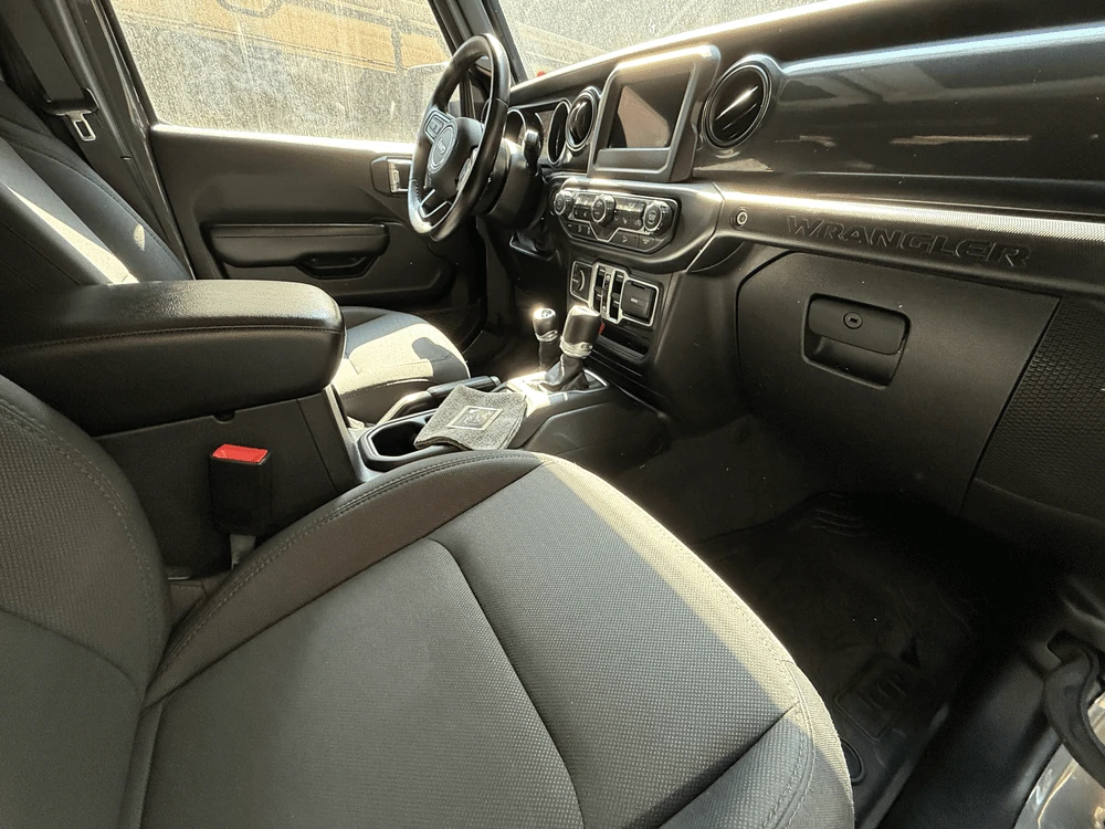 Passenger side interior view of the front seats, center console, and dashboard