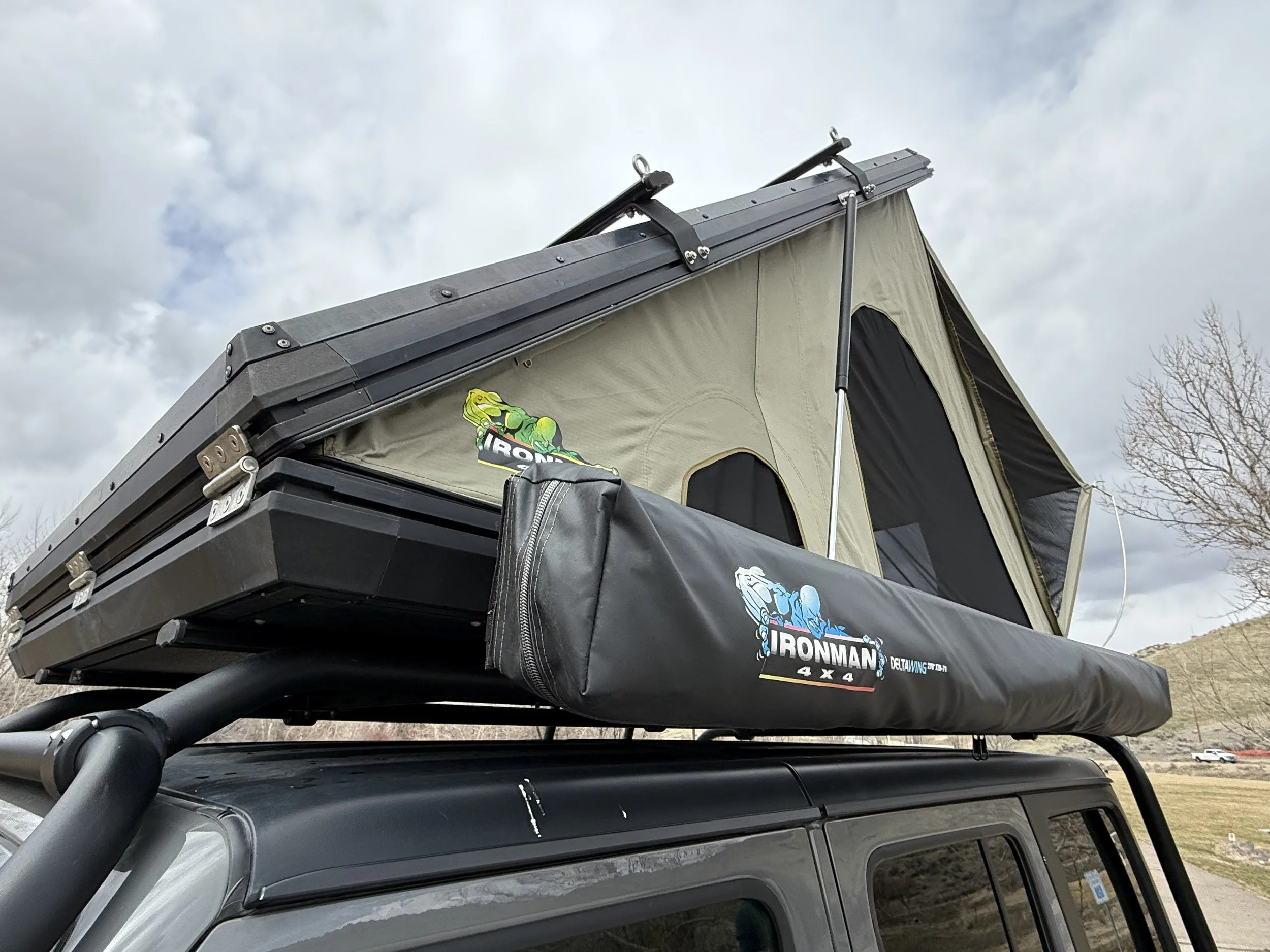 Close-up detail of the Ironman 4x4 rooftop tent mounted on the roof rack