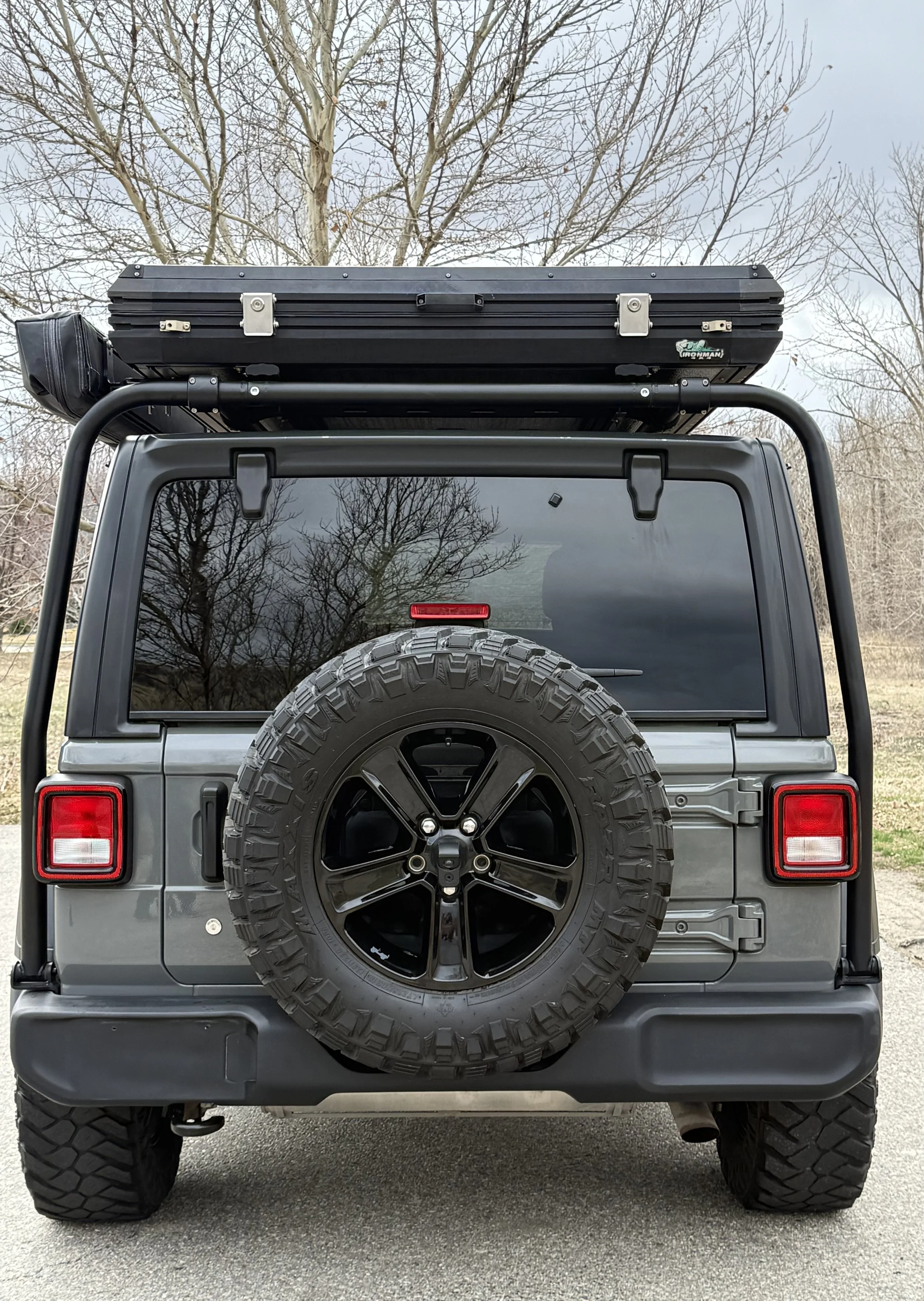 Rear view of the fully equipped overland Jeep with rooftop tent and roof rack