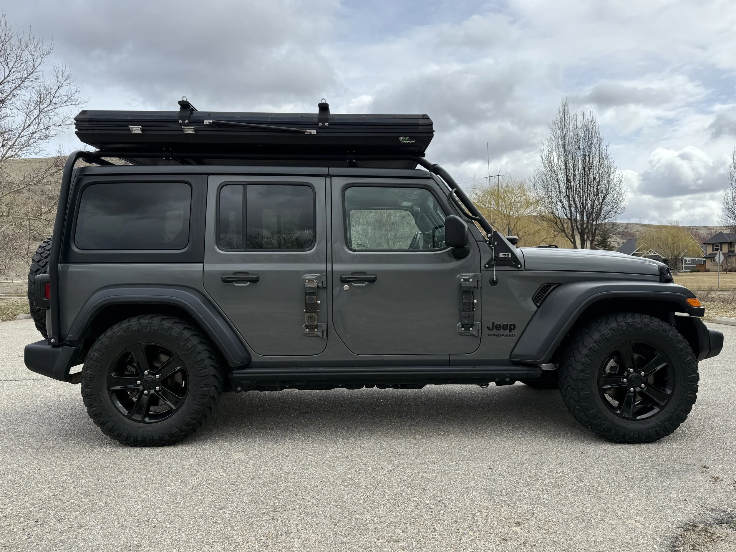Side profile of the overland Jeep with rooftop tent closed, ready to drive